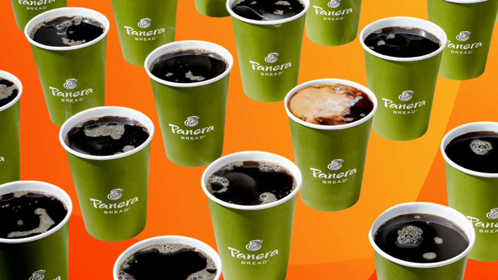 Numerous green cups filled with dark coffee, each labeled "Panera Bread," are scattered across a vibrant orange background. One cup is topped with creamy foam.