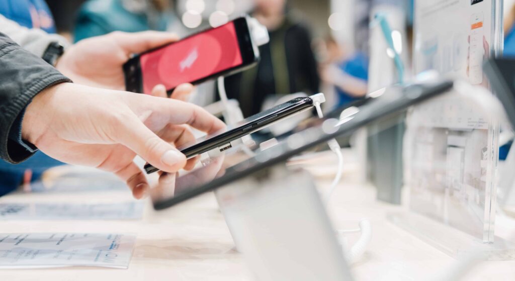 AdobeStock_176020704 (2) Person holding iphone in store apple marketing strategy