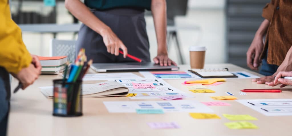 Close up ux developer and ui designer brainstorming about mobile