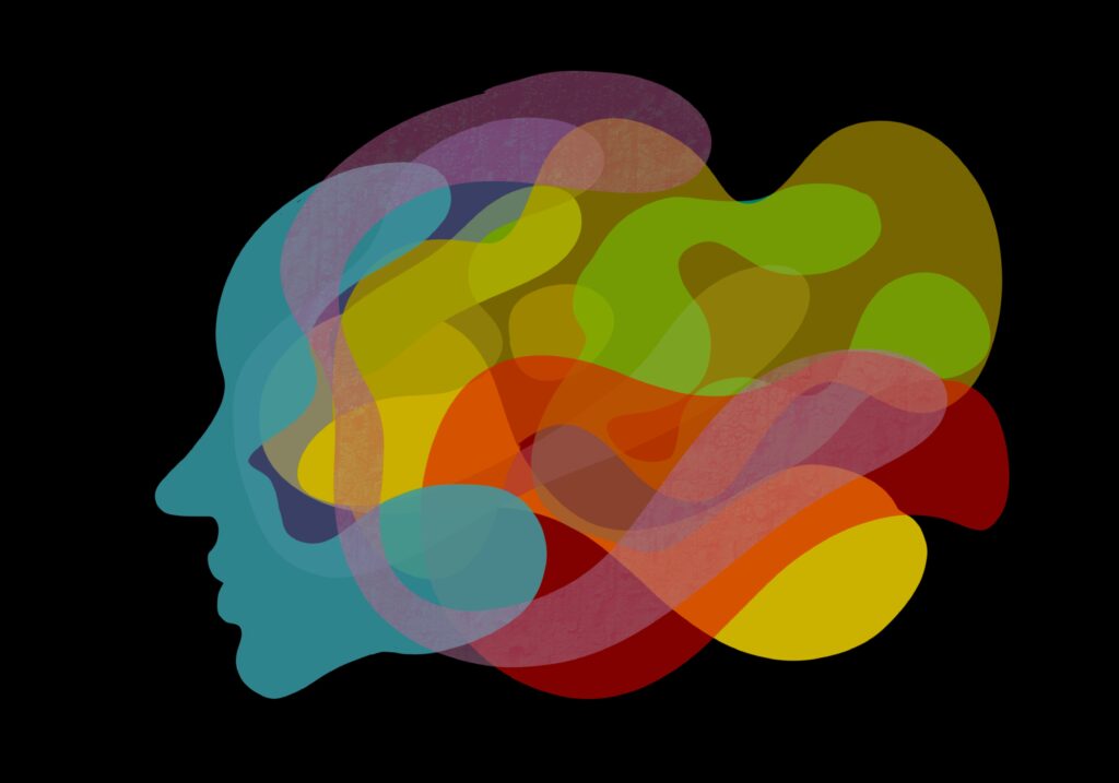 Silhouette of a head filled with colorful abstract shapes on a black background, symbolizing diverse thoughts or creativity.